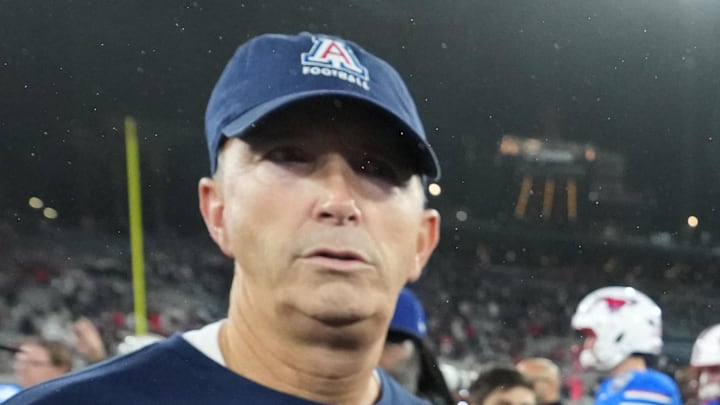 Jan 2, 2026; San Diego, CA, USA; Arizona Wildcats head coach Brent Brennan (left) and SMU Mustangs head coach Rhett Lashlee shake hands after the Holiday Bowl at Snapdragon Stadium. Mandatory Credit: Kirby Lee-Imagn Images