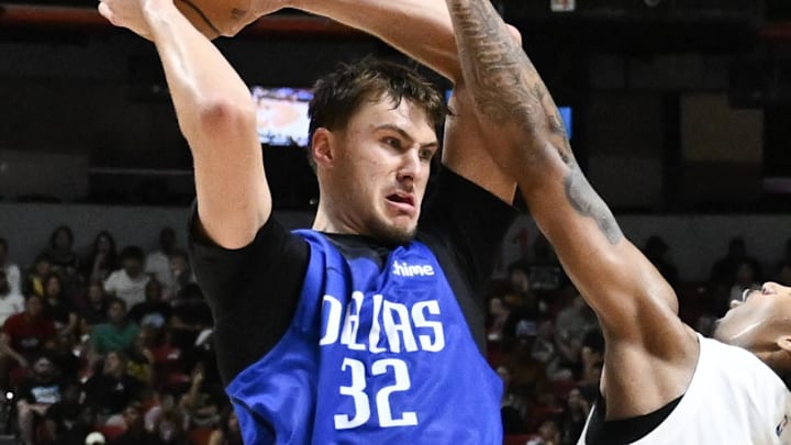 Jul 12, 2025; Las Vegas, NV, USA; Dallas Mavericks forward Cooper Flagg (32) passes the ball against San Antonio Spurs center Nathan Mensah (31) and guard Dylan Harper (2) in the third quarter of their game at Thomas & Mack Center. Mandatory Credit: Candice Ward-Imagn Images