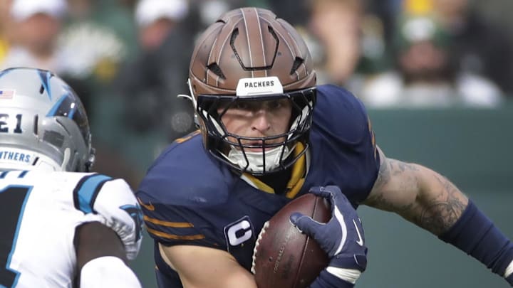 Green Bay Packers tight end Tucker Kraft (85) runs on a catch against Carolina Panthers safety Nick Scott on Sunday.