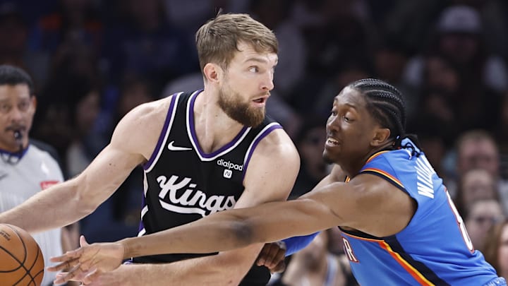 Apr 9, 2024; Oklahoma City, Oklahoma, USA; Oklahoma City Thunder forward Jalen Williams (8) defends Sacramento Kings forward Domantas Sabonis (10) during the second half at Paycom Center.