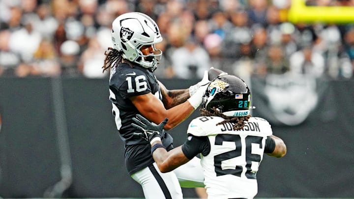 Nov 2, 2025; Paradise, Nevada, USA; Jacksonville Jaguars safety Antonio Johnson (26) tackles Las Vegas Raiders wide receiver Jakobi Meyers (16) during the second half at Allegiant Stadium. Mandatory Credit: Stephen R. Sylvanie-Imagn Images
