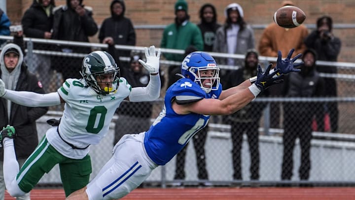 Novi Detroit Catholic Central's Jack Janda stretches out but fails to pull in the pass while covered by Detroit Cass Tech's Lamont Wilcoxson in the fourth quarter during the MHSAA Division 1 semifinals at Troy Athens High School on Saturday, Nov. 23, 2024.