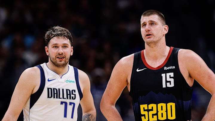 Dec 18, 2023; Denver, Colorado, USA; Dallas Mavericks guard Luka Doncic (77) and Denver Nuggets center Nikola Jokic (15) in the second quarter at Ball Arena. Mandatory Credit: Isaiah J. Downing-Imagn Images