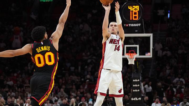 Apr 12, 2026; Miami, Florida, USA;  Miami Heat guard Tyler Herro (14) shoots over Atlanta Hawks guard Rayj Dennis (00) during the second half at Kaseya Center. Mandatory Credit: Jim Rassol-Imagn Images