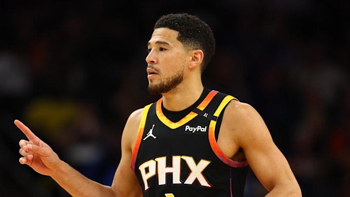 Apr 9, 2025; Phoenix, Arizona, USA; Phoenix Suns guard Devin Booker (1) reacts after a play against the Oklahoma City Thunder during the first half at Footprint Center. Mandatory Credit: Mark J. Rebilas-Imagn Images