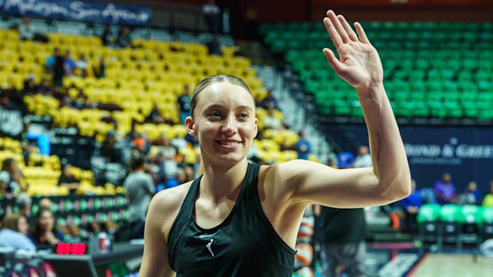 Dallas Wings guard Paige Bueckers waves to fans.