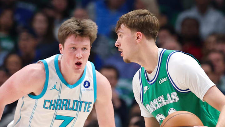 Jan 29, 2026; Dallas, Texas, USA;  Dallas Mavericks forward Cooper Flagg (32) controls the ball as Charlotte Hornets guard Kon Knueppel (7) defends during the first quarter at American Airlines Center. Mandatory Credit: Kevin Jairaj-Imagn Images