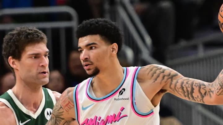 Jan 23, 2025; Milwaukee, Wisconsin, USA; Miami Heat center Kel'el Ware (7) is guarded by Milwaukee Bucks center Brook Lopez (11)in the third quarter at Fiserv Forum. Mandatory Credit: Benny Sieu-Imagn Images