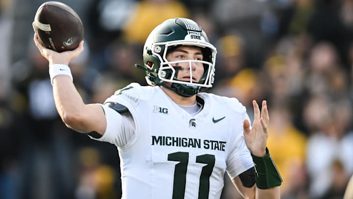 Nov 22, 2025; Iowa City, Iowa, USA; Michigan State Spartans quarterback Alessio Milivojevic (11) throws a pass against the Iowa Hawkeyes during the first quarter at Kinnick Stadium. Mandatory Credit: Jeffrey Becker-Imagn Images