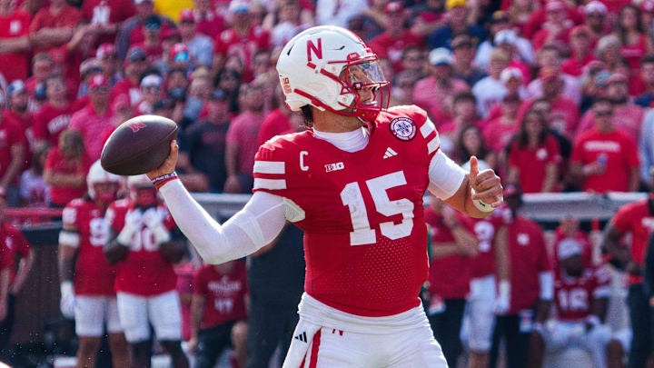 Sep 20, 2025; Lincoln, Nebraska, USA; Nebraska Cornhuskers quarterback Dylan Raiola (15) throws a touchdown pass against the Michigan Wolverines during the second quarter at Memorial Stadium. 