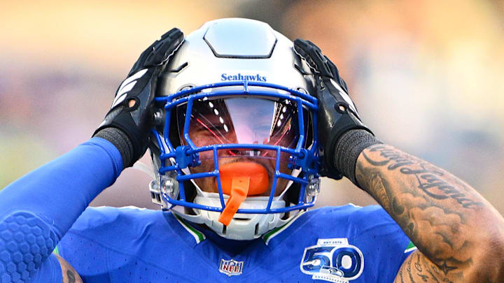 Elijah Arroyo of the Seattle Seahawks holds his head