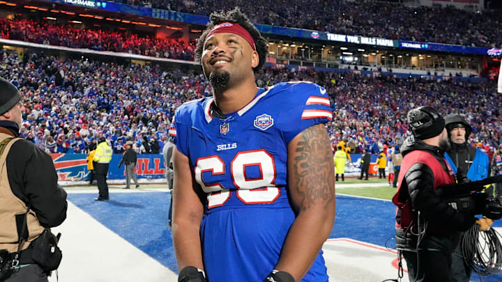 Bills tackle Tylan Grable smiles as he stops and watches a tribute video on the scoreboards as he leaves the field following the Bills win over the Jets.