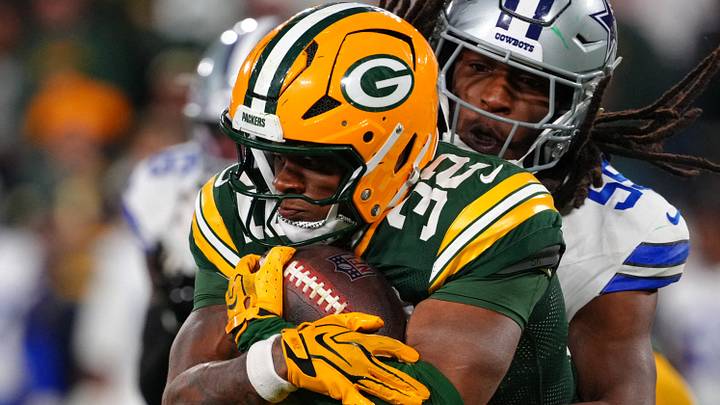 Green Bay Packers running back MarShawn Lloyd (32) runs the ball against Dallas Cowboys linebacker Jaishawn Barham. Green Bay Packers running back MarShawn Lloyd (32) runs the ball against Dallas Cowboys linebacker Jaishawn Barham.