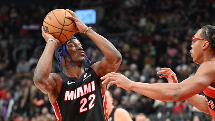 Dec 1, 2024; Toronto, Ontario, CAN;  Miami Heat forward Jimmy Butler (22) looks to shoot the ball against Toronto Raptors forward Scottie Barnes (4) in the first half at Scotiabank Arena. Mandatory Credit: Dan Hamilton-Imagn Images