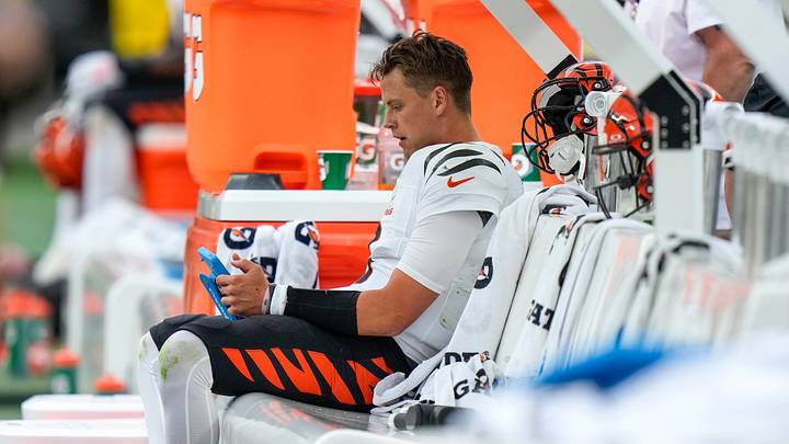 Cincinnati Bengals quarterback Joe Burrow (9) sits on the bench to watch film after giving up a fumble to seal the game in the fourth quarter of the NFL Week 3 game between the Pittsburgh Steelers and the Cincinnati Bengals at Acrisure Stadium in Pittsburgh on Sunday, Sept. 27, 2026. The Bengals fell to 2-1 on the season with a 30-27 loss on the road.
