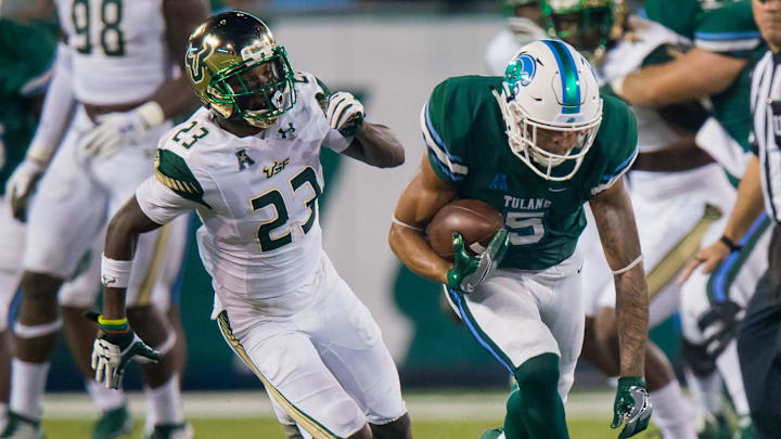 Oct 21, 2017; New Orleans, LA, USA; Tulane Green Wave wide receiver Terren Encalade (5) is tackled by South Florida Bulls cornerback Mazzi Wilkins (23) during the second half at Yulman Stadium. South Florida won 34-28. Mandatory Credit: Stephen Lew-Imagn Images