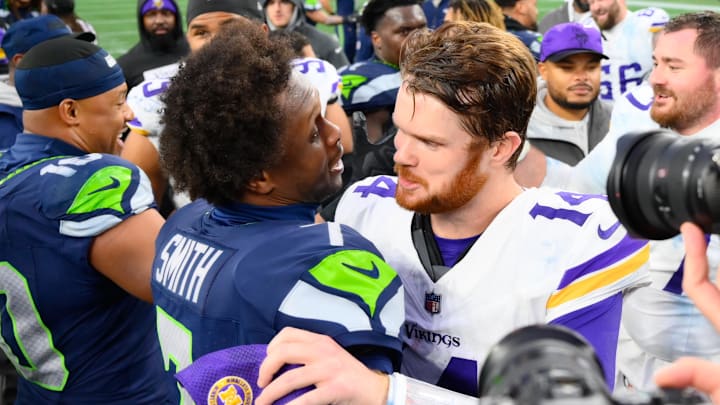 Dec 22, 2024; Seattle, Washington, USA; Seattle Seahawks quarterback Geno Smith (7) and Minnesota Vikings quarterback Sam Darnold (14) hug after the game at Lumen Field. Dec 22, 2024; Seattle, Washington, USA; Seattle Seahawks quarterback Geno Smith (7) and Minnesota Vikings quarterback Sam Darnold (14) hug after the game at Lumen Field.