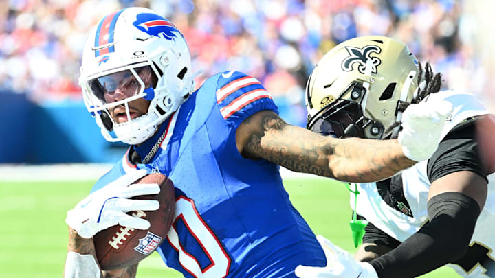 Sep 28, 2025; Orchard Park, New York, USA; Buffalo Bills wide receiver Keon Coleman (0) runs for a gain past New Orleans Saints cornerback Kool-Aid McKinstry (4) during the first quarter at Highmark Stadium. Mandatory Credit: Mark Konezny-Imagn Images