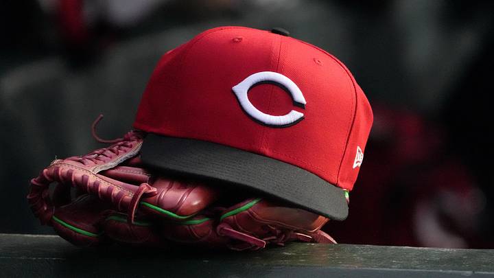 May 5, 2026; Chicago, Illinois, USA; A detail shot of Cincinnati Reds hat and glove in the dugout during the fourth inning against the Chicago Cubs at Wrigley Field. Mandatory Credit: David Banks-Imagn Images May 5, 2026; Chicago, Illinois, USA; A detail shot of Cincinnati Reds hat and glove in the dugout during the fourth inning against the Chicago Cubs at Wrigley Field. Mandatory Credit: David Banks-Imagn Images