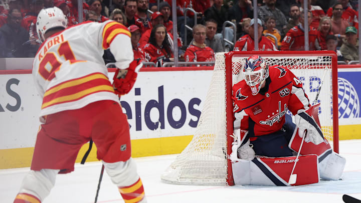 Feb 25, 2025; Washington, District of Columbia, USA; Calgary Flames center Nazem Kadri (91) prepares to shoot the puck on .Washington Capitals goaltender Logan Thompson (48) as Capitals defenseman Trevor van Riemsdyk (57) defends in the second period at Capital One Arena. Mandatory Credit: Geoff Burke-Imagn Images