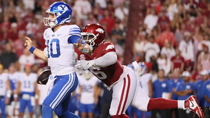 Arkansas Razorbacks defensive lineman John Morgan III (6) knocks the ball loose from BYU Cougars quarterback Kedon Slovis (10) during the second quarter at Donald W. Reynolds Razorback Stadium. 