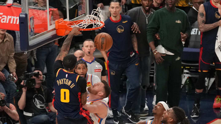 Golden State Warriors guard Gary Payton II dunks the ball over Oklahoma City Thunder center Isaiah Hartenstein.
