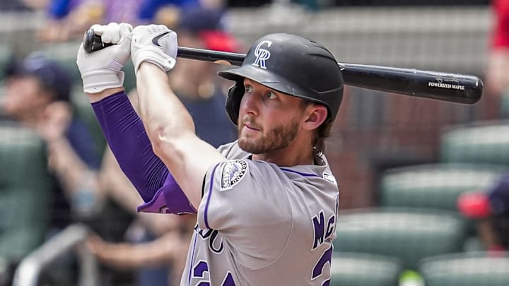 Jun 15, 2025; Cumberland, Georgia, USA; Colorado Rockies third baseman Ryan McMahon (24) hits a home run against the Atlanta Braves during the seventh inning at Truist Park. Jun 15, 2025; Cumberland, Georgia, USA; Colorado Rockies third baseman Ryan McMahon (24) hits a home run against the Atlanta Braves during the seventh inning at Truist Park.