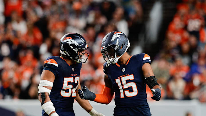 Sep 29, 2025; Denver, Colorado, USA; Denver Broncos linebacker Nik Bonitto (15) celebrates with Denver Broncos linebacker Jonah Elliss (52) after sacking Cincinnati Bengals quarterback Jake Browning (6) (not pictured) during the third quarter at Empower Field at Mile High. Mandatory Credit: Isaiah J. Downing-Imagn Images