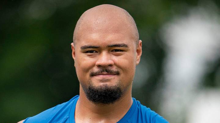 Detroit Lions OT Giovanni Manu walks off the field after he works out.