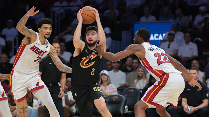 Apr 26, 2025; Miami, Florida, USA; Cleveland Cavaliers guard Ty Jerome (2) drives to the basket past Miami Heat center Kel'el Ware (7) and forward Andrew Wiggins (22) in the first quarter during game three for the first round of the 2024 NBA Playoffs at Kaseya Center. Mandatory Credit: Sam Navarro-Imagn Images