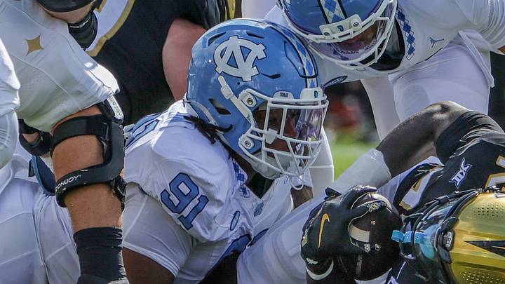 Sep 20, 2025; Orlando, Florida, USA; UCF Knights running back Myles Montgomery (22) is tackled by North Carolina Tar Heels defensive lineman Leroy Jackson (91) during the first quarter at the Bounce House Stadium. Mandatory Credit: Mike Watters-Imagn Images Sep 20, 2025; Orlando, Florida, USA; UCF Knights running back Myles Montgomery (22) is tackled by North Carolina Tar Heels defensive lineman Leroy Jackson (91) during the first quarter at the Bounce House Stadium. Mandatory Credit: Mike Watters-Imagn Images