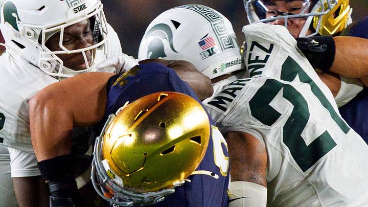 Notre Dame running back Nolan James Jr., center, gets wrapped up with the ball during a NCAA football game against Michigan State at Notre Dame Stadium on Saturday, Sept. 19, 2026, in South Bend.