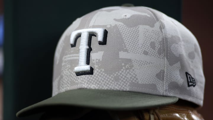 May 18, 2025; Arlington, Texas, USA;  Texas Rangers hat in honor of the military in the dugout  during the second inning against the Houston Astros at Globe Life Field. 