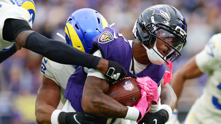 Oct 12, 2025; Baltimore, Maryland, USA; Baltimore Ravens wide receiver Zay Flowers (4) carries the ball against the Los Angeles Rams during the fourth quarter of the game at M&T Bank Stadium. Mandatory Credit: Peter Casey-Imagn Images Oct 12, 2025; Baltimore, Maryland, USA; Baltimore Ravens wide receiver Zay Flowers (4) carries the ball against the Los Angeles Rams during the fourth quarter of the game at M&T Bank Stadium. Mandatory Credit: Peter Casey-Imagn Images