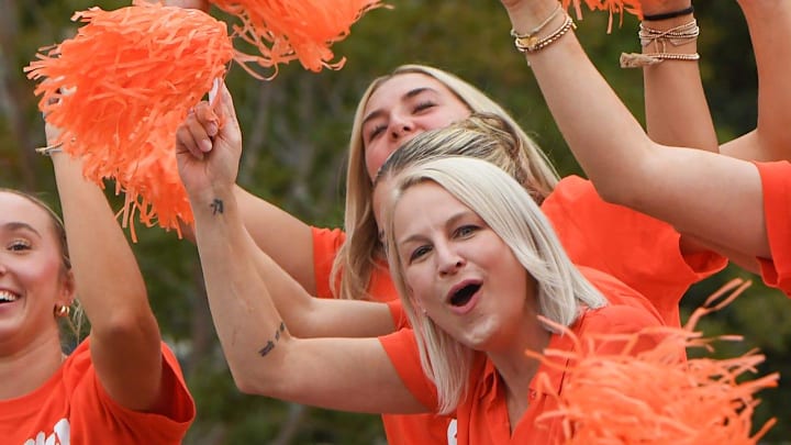 Grand Marshal Amy Smith, the Gymnastics team head coach, cheers and waves with athletes during Clemson University's 50th First Friday parade in Clemson, S.C. Friday, September 6, 2024. Clemson plays Appalachian State September 7.