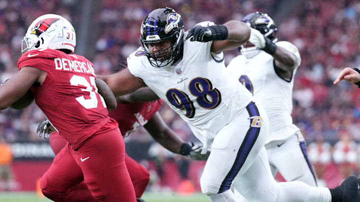 Oct 29, 2023; Glendale, Arizona, USA; Baltimore Ravens defensive tackle Travis Jones (98) pursues Arizona Cardinals running back Emari Demercado (31) during the second half at State Farm Stadium. Mandatory Credit: Joe Camporeale-Imagn Images