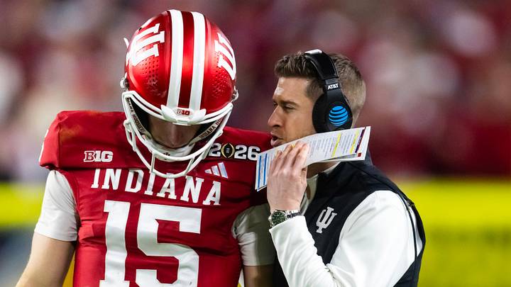 Jan 19, 2026; Miami Gardens, FL, USA; Indiana Hoosiers quarterback Fernando Mendoza (15) with quarterbacks coach Chandler Whitmer against the Miami Hurricanes in the College Football Playoff National Championship game at Hard Rock Stadium. Mandatory Credit: Mark J. Rebilas-Imagn Images Jan 19, 2026; Miami Gardens, FL, USA; Indiana Hoosiers quarterback Fernando Mendoza (15) with quarterbacks coach Chandler Whitmer against the Miami Hurricanes in the College Football Playoff National Championship game at Hard Rock Stadium. Mandatory Credit: Mark J. Rebilas-Imagn Images
