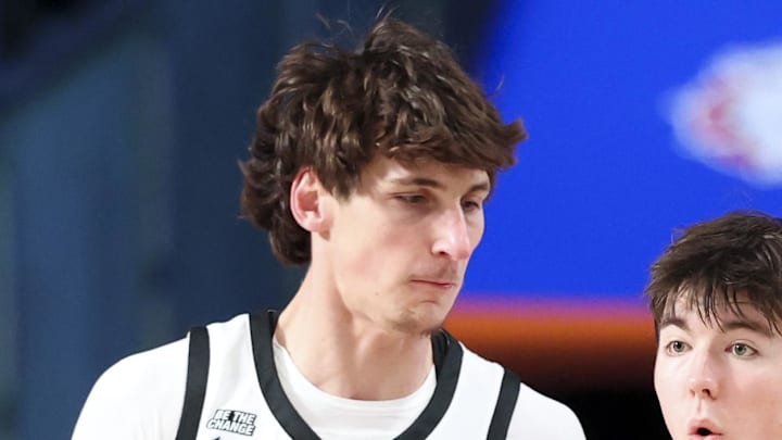 Nov 28, 2024;  Paradise Island, Bahamas, BHS; Davidson Wildcats forward Sean Logan (15) dribbles as Providence Friars center Anton Bonke (5) defends during the first half at the Imperial Arena at the Atlantis Resort.