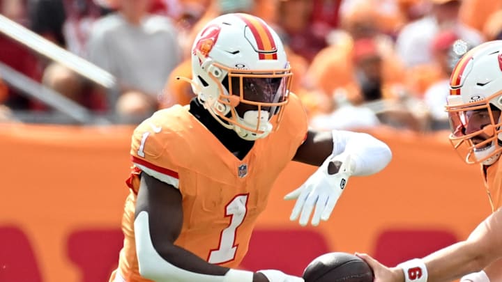 Oct 27, 2024; Tampa, Florida, USA; Tampa Bay Buccaneers quarterback Baker Mayfield (6) hands off to  running back Rachaad White (1)in the first half against the Atlanta Falcons at Raymond James Stadium. Mandatory Credit: Jonathan Dyer-Imagn Images