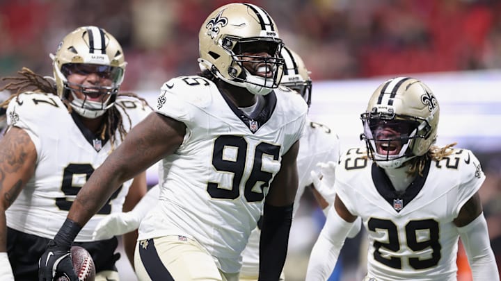 New Orleans Saints DE Carl Granderson (96) celebrates with DT Khristian Boyd (97) and CB Quincy Riley (29) after picking off Atlanta Falcons QB Kirk Cousins on Jan. 4, 2026.