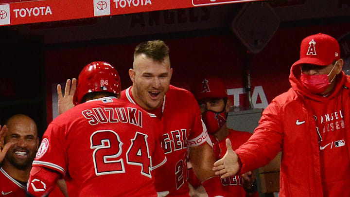 Angels catcher Kurt Suzuki (24) is greeted by center fielder Mike Trout (27) after hitting a two run home run against the Texas Rangers during the seventh inning at Angel Stadium on Apr 20, 2021. Angels catcher Kurt Suzuki (24) is greeted by center fielder Mike Trout (27) after hitting a two run home run against the Texas Rangers during the seventh inning at Angel Stadium on Apr 20, 2021.