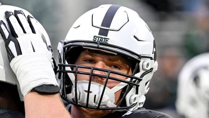 Michigan State's Matt Gulbin, right, hugs quarterback Aidan Chiles before the football game against Boston College on Saturday, Sept. 6, 2025, at Spartan Stadium in East Lansing.
