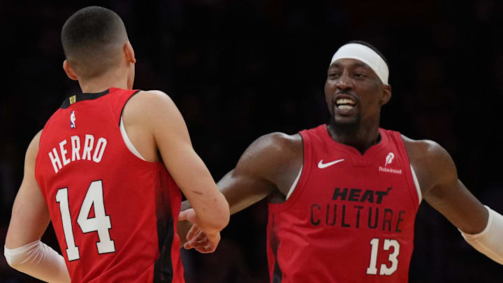 Dec 7, 2024; Miami, Florida, USA;  Miami Heat center Bam Adebayo (13) celebrates with guard Tyler Herro (14) after Herro made a three-point basket against the Phoenix Suns during the second half at Kaseya Center. Mandatory Credit: Jim Rassol-Imagn Images