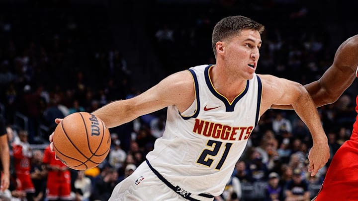 Oct 15, 2023; Denver, Colorado, USA; Denver Nuggets guard Collin Gillespie (21) controls the ball under pressure from Chicago Bulls forward Terry Taylor (32) in the fourth quarter at Ball Arena. Mandatory Credit: Isaiah J. Downing-Imagn Images
