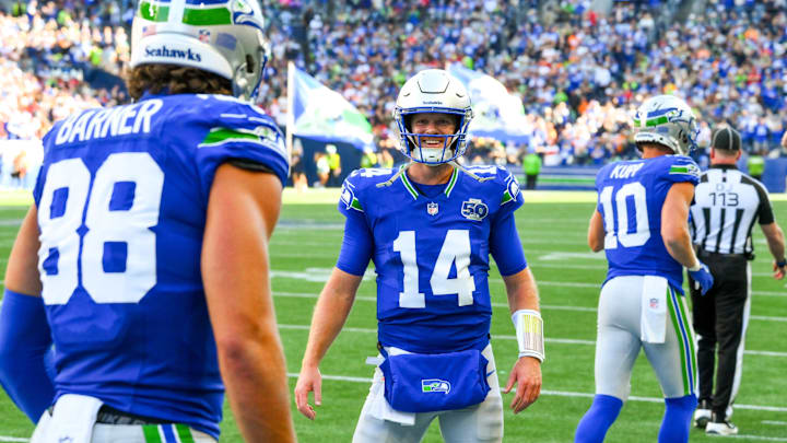 Oct 5, 2025; Seattle, Washington, USA;  Seattle Seahawks quarterback Sam Darnold (14) reacts with tight end AJ Barner (88) after a touchdown against the Tampa Bay Buccaneers during the second half at Lumen Field.