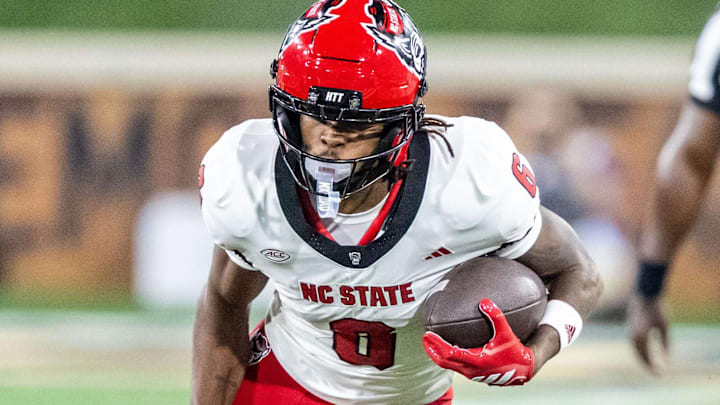 Sep 11, 2025; Winston-Salem, North Carolina, USA;  North Carolina State Wolfpack wide receiver Keenan Jackson (8) runs past Wake Forest Demon Deacons defensive back Nick Andersen (45) in the second half at Allegacy Federal Credit Union Stadium. Mandatory Credit: Luke Jamroz-Imagn Images