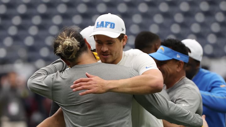 Jan 11, 2025; Houston, Texas, USA; Los Angeles Chargers quarterback Justin Herbert (10) hugs a teammate before playing against the Houston Texans in an AFC wild card game at NRG Stadium. Mandatory Credit: Thomas Shea-Imagn Images