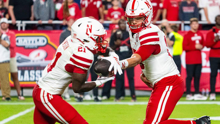 Emmett Johnson takes a handoff from Dylan Raiola during last week's game against Cincinnati.
