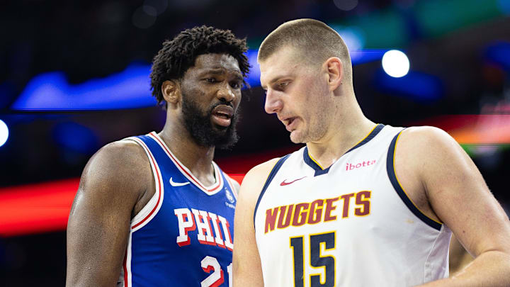 Jan 16, 2024; Philadelphia, Pennsylvania, USA; Philadelphia 76ers center Joel Embiid (21) glances at Denver Nuggets center Nikola Jokic (15) during a break in action in the third quarter at Wells Fargo Center.