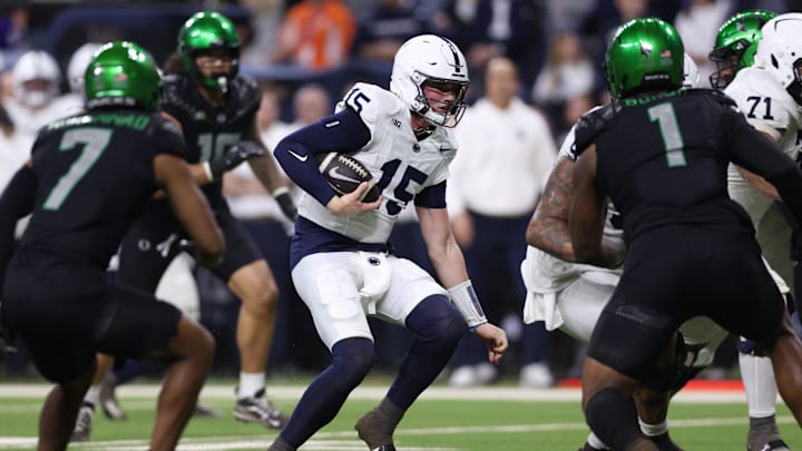 Penn State football quarterback Drew Allar (15) runs for a gain against the Oregon Ducks during the 2024 Big Ten Championship Game